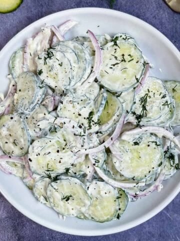 creamy cucumber salad with dill and sour cream served on a plate