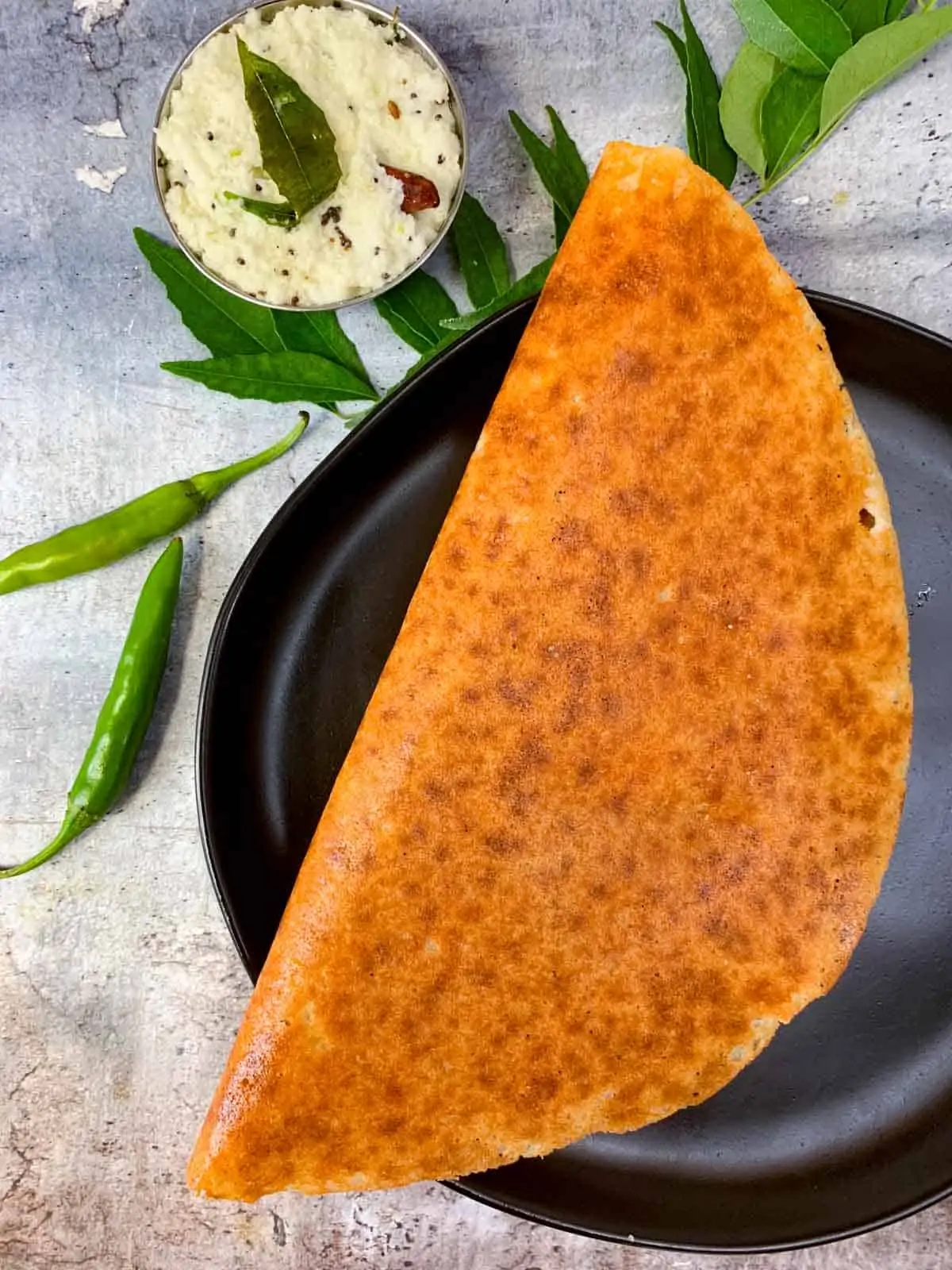 keto almond flour dosa served in a plate with coconut chutney on the side