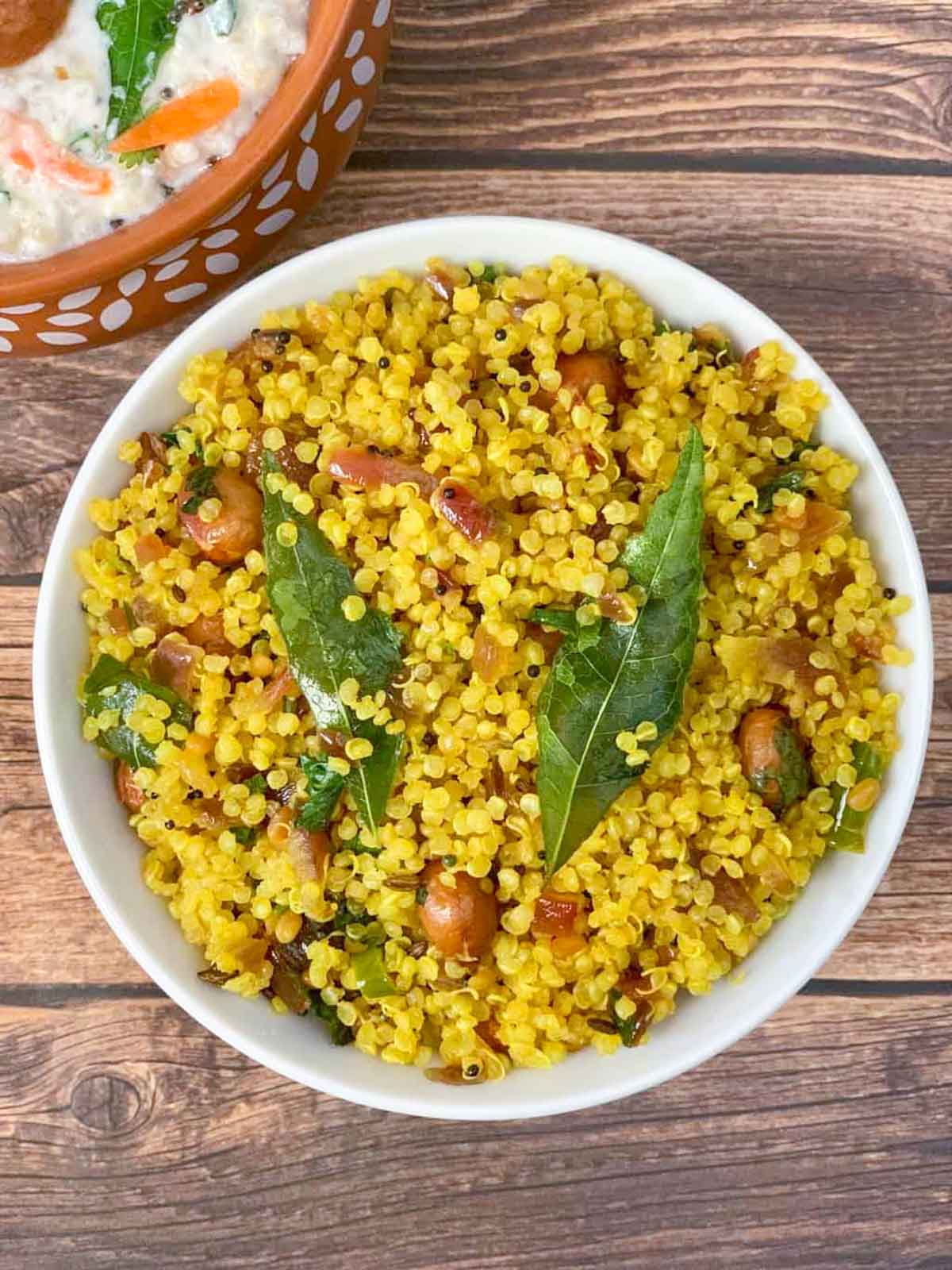 lemon quinoa served in a bowl with curd rice on the side
