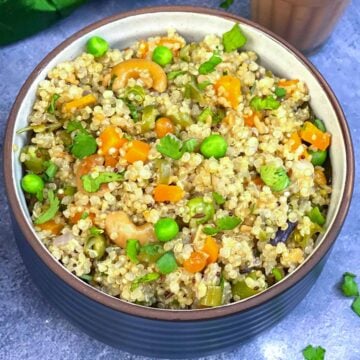 quinoa upma served in a bowl with masala chai on the side