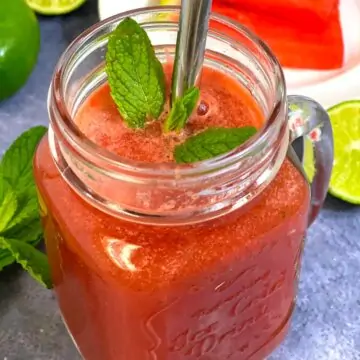 watermelon juice with lime and mint served in a masor jar garnished with mint leaves