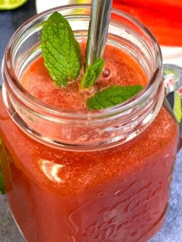 watermelon juice with lime and mint served in a masor jar garnished with mint leaves