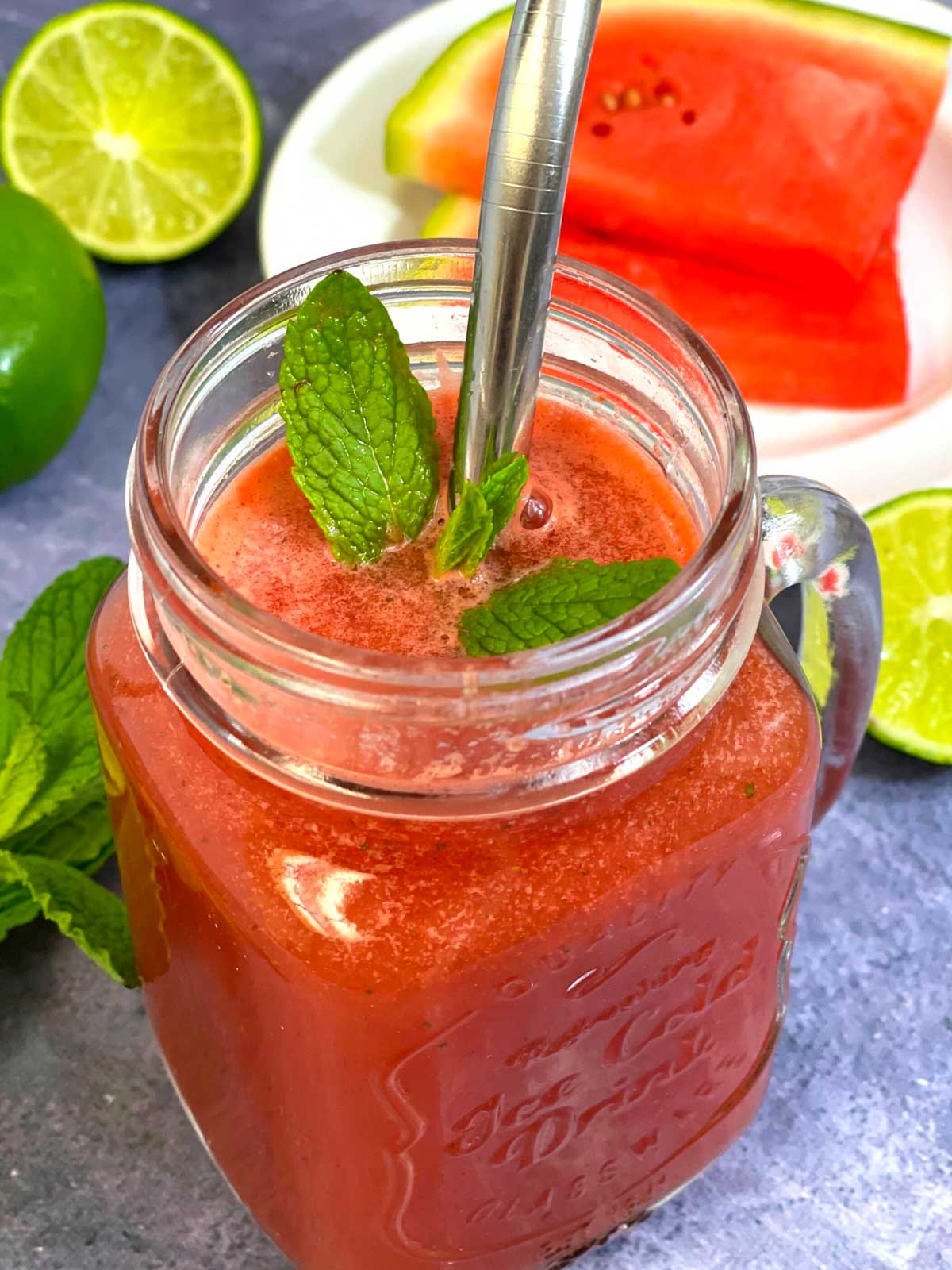 watermelon juice with lime and mint served in a masor jar garnished with mint leaves