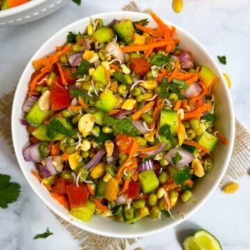 sprouted moong (mung) salad recipe served in a bowl with lemon wedge on the side