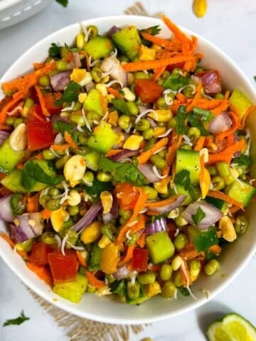 sprouted moong (mung) salad recipe served in a bowl with lemon wedge on the side