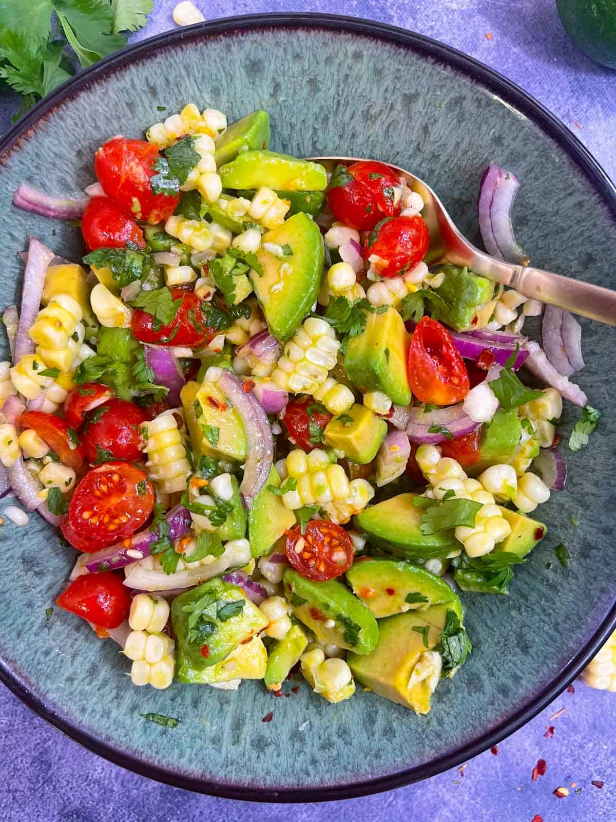 Avocado Corn Salad served in a bowl with a spoon