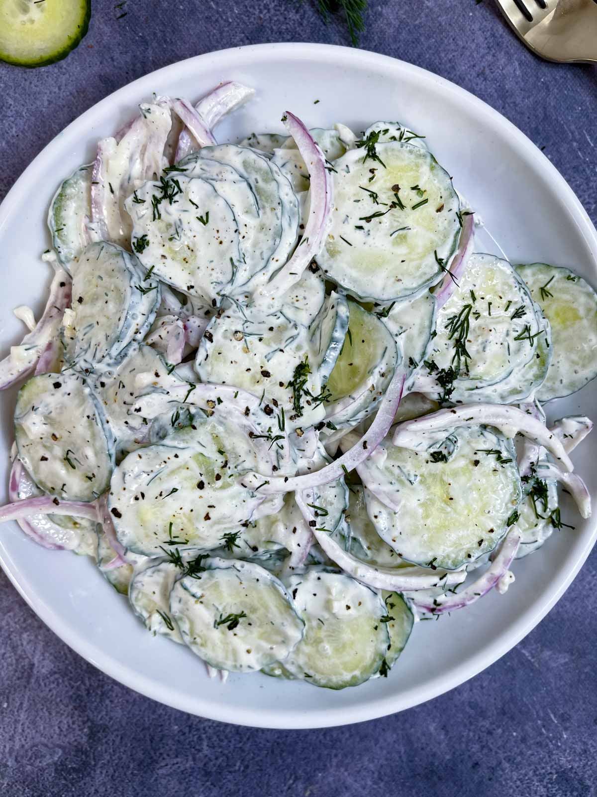 creamy cucumber salad with dill and sour cream served on a plate