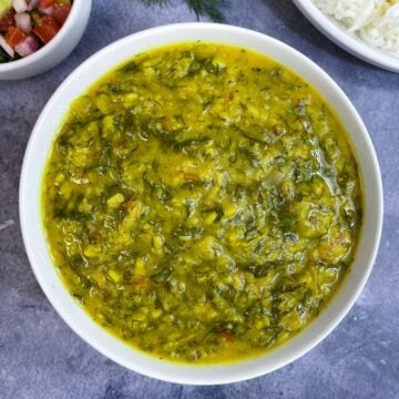 Dill Leaves Dal served in a bowl with rice and salad ont he side