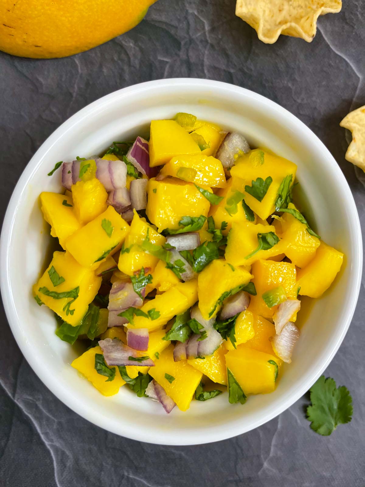 Fresh mango salsa served in a bowl garnished with cilantro