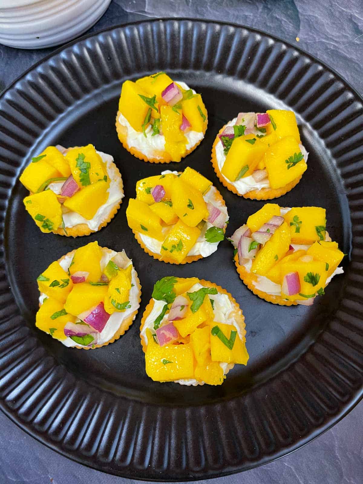 Mango Salsa and cream cheese appetizer served on a plate