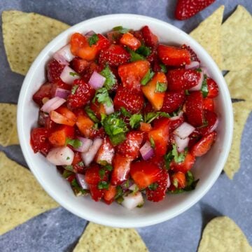 strawberry salsa in a bowl with chips on the side