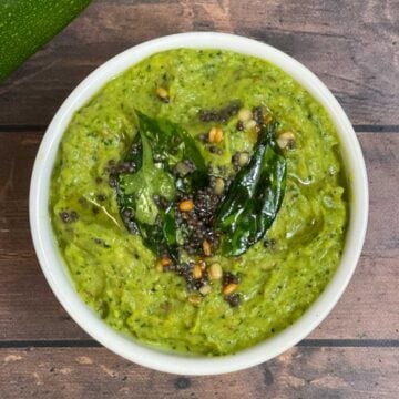 zucchini chutney served in a bowl with tempering on the top