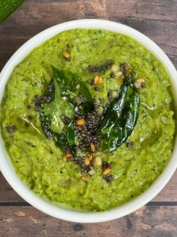 zucchini chutney served in a bowl with tempering on the top