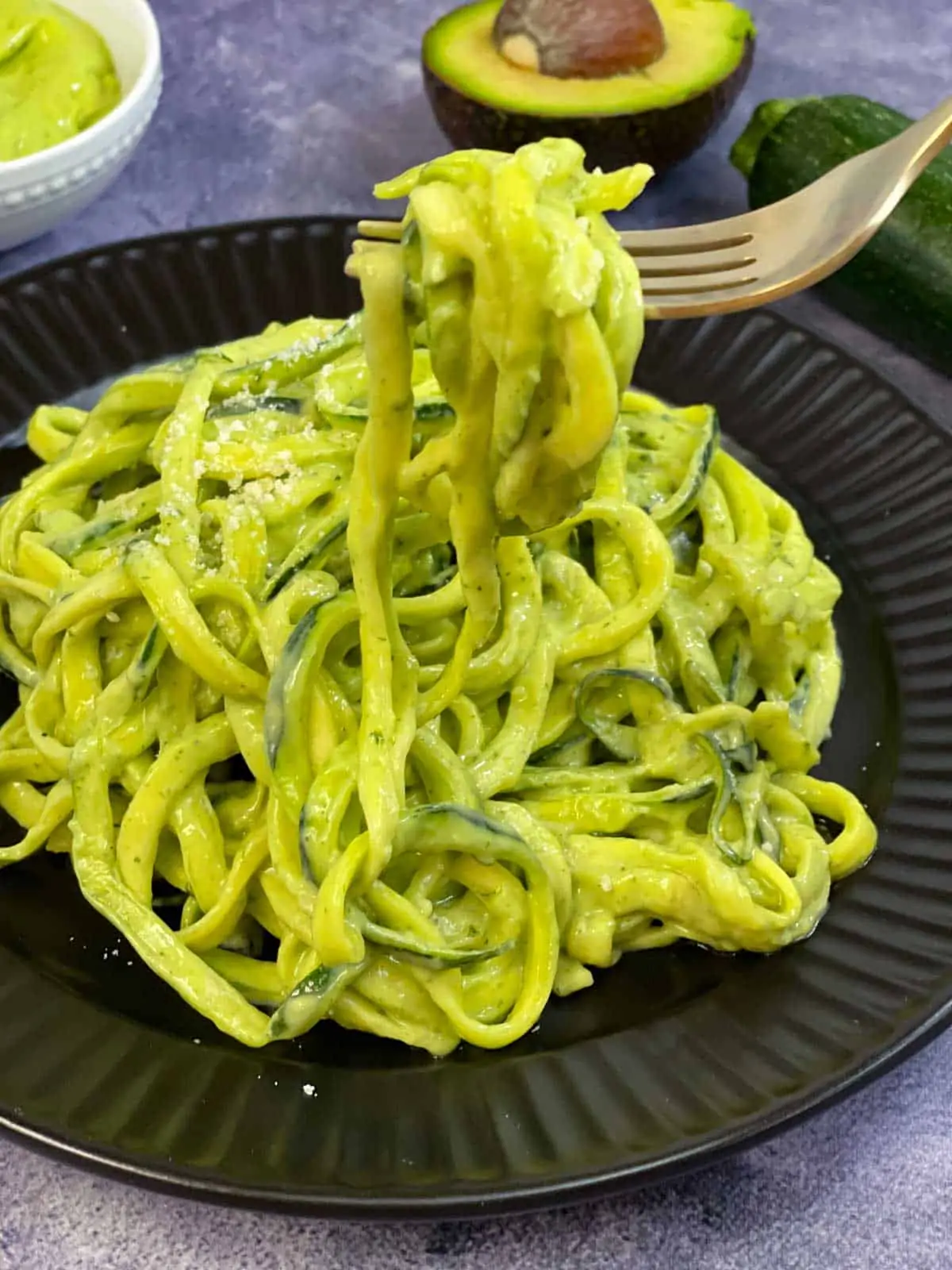 zucchini pasta in a fork served on a plate