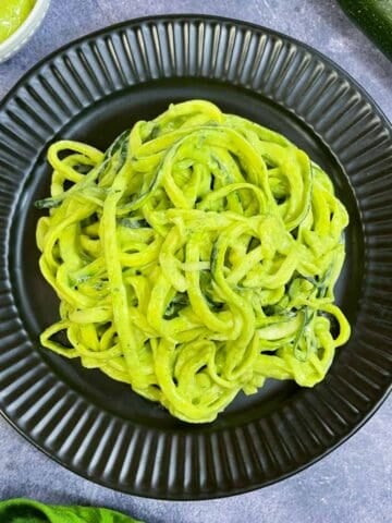 zucchini pasta with avocado sauce served on a plate