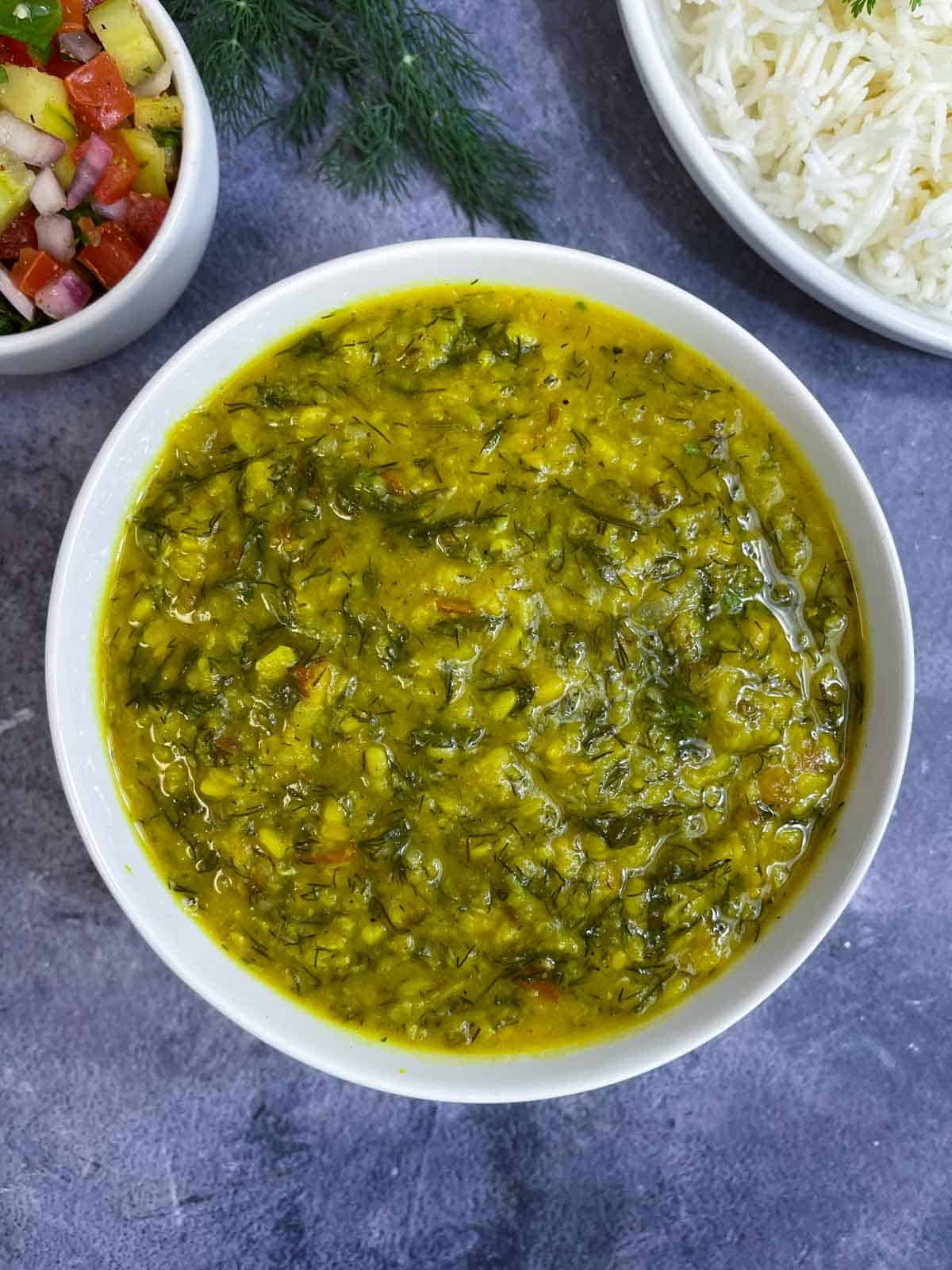 Dill Leaves Dal served in a bowl with side of rice and kachumber salad