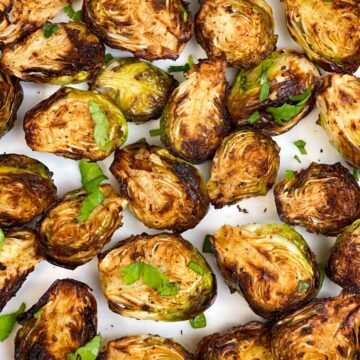 brussel sprouts served on a plate garnished with cilantro