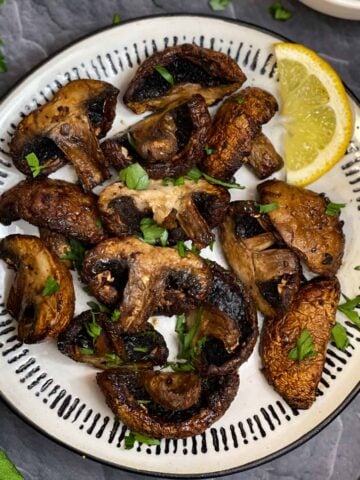 air fried mushrooms on the plate with a lemon wedge