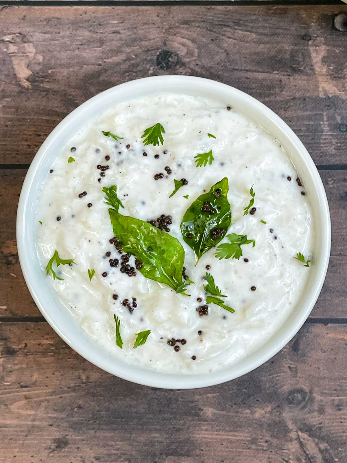 Poosanikai Thayir Pachadi  served in a bowl garnished with cilantro