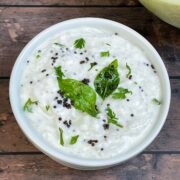 ash gourd raita served in a bowl garnished with cilantro