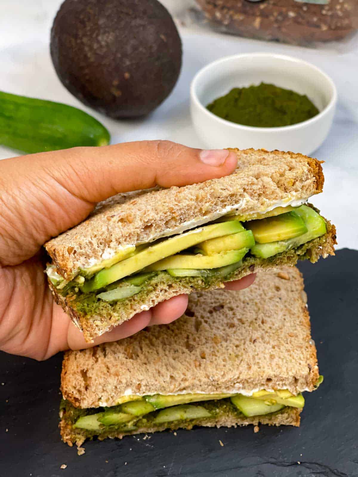 avocado chutney sandwich held in a hand
