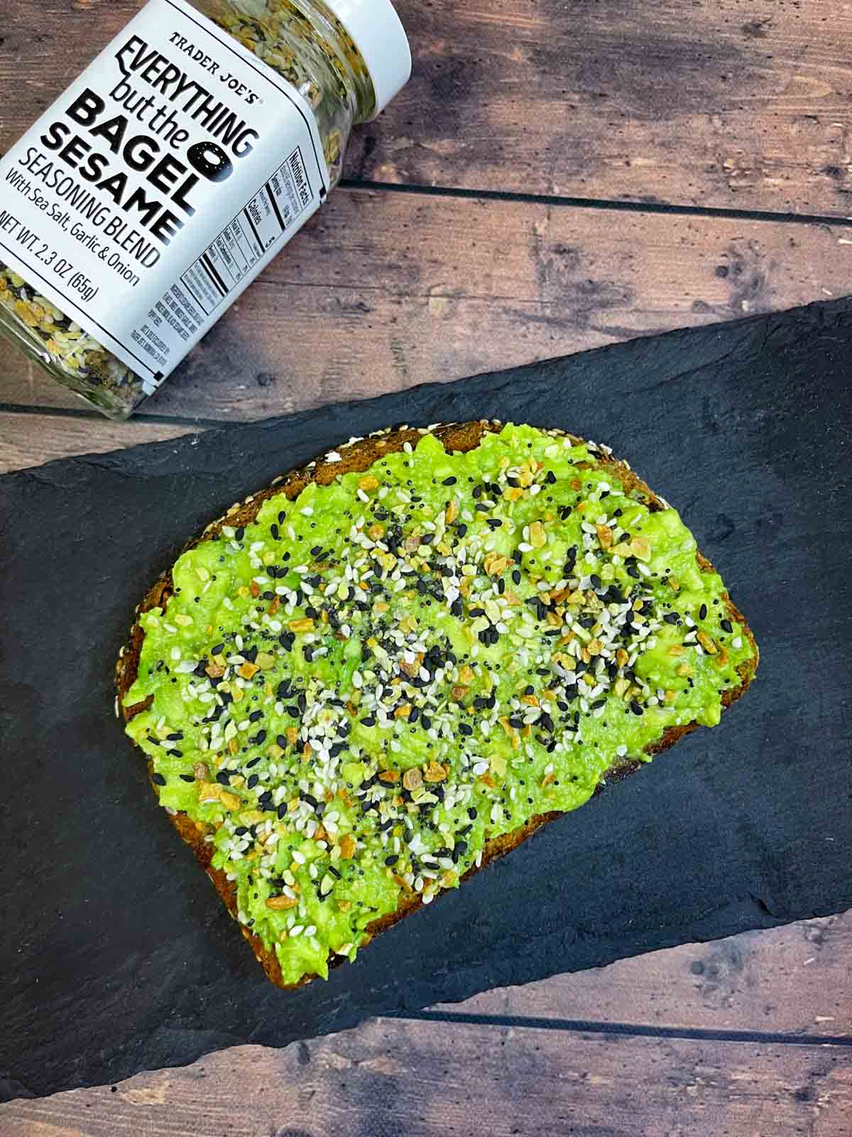 avocado toast with everything bagel seasoning placed on a black slate 