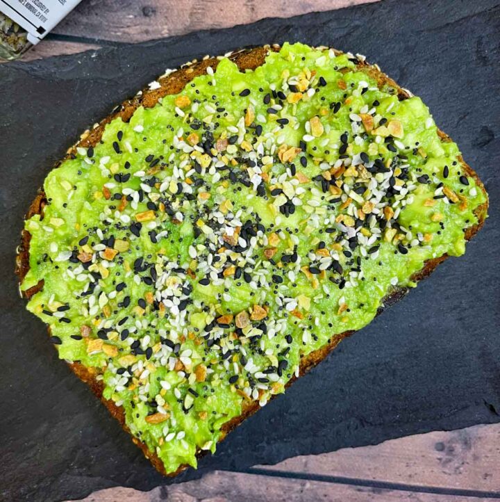 avocado toast with everything bagel seasoning placed on a black slate