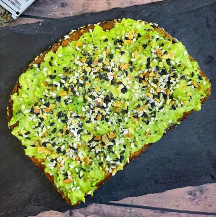 avocado toast with everything bagel seasoning placed on a black slate