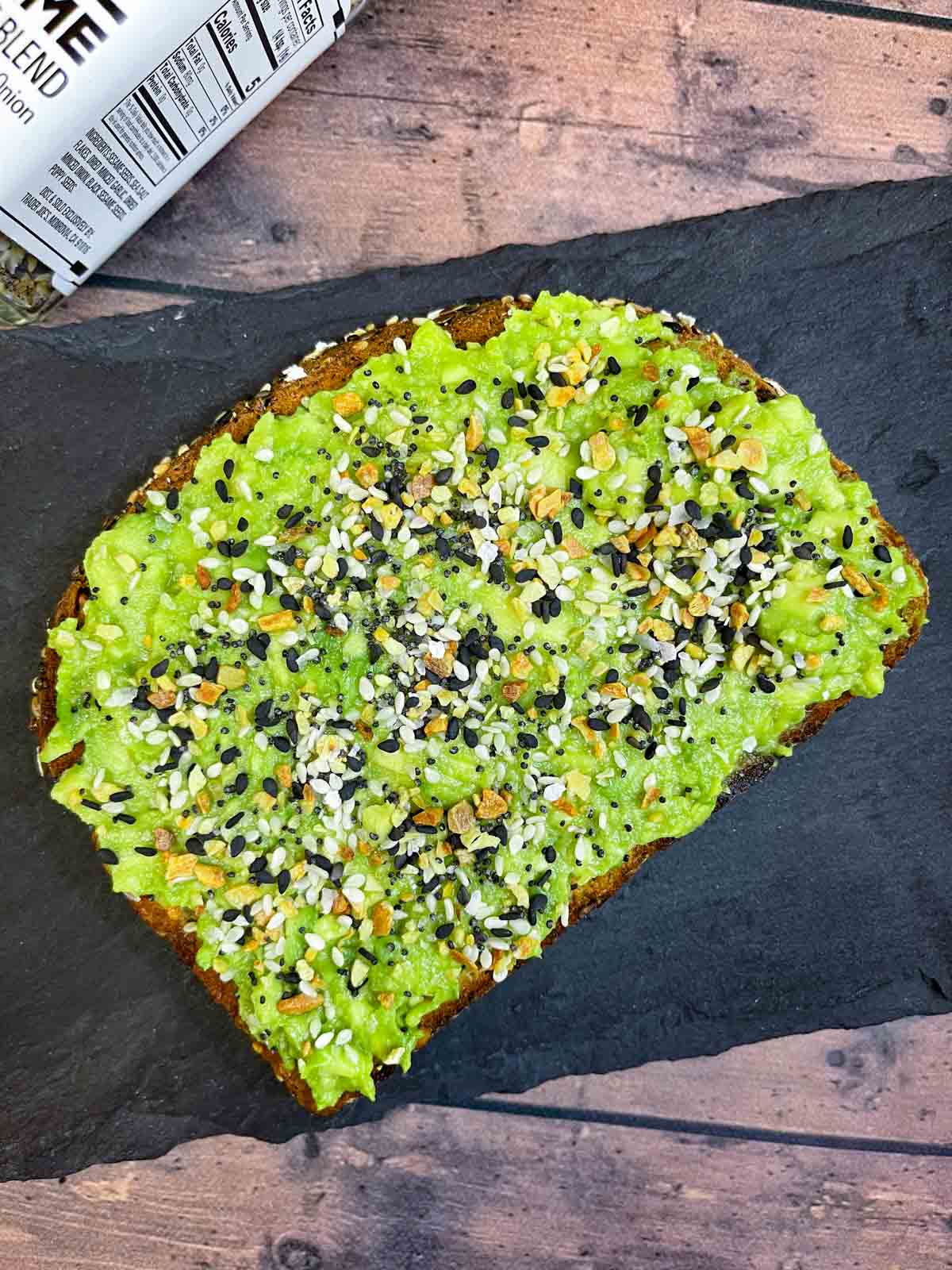 avocado toast with everything bagel seasoning placed on a black slate 