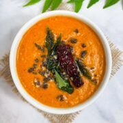 chana dal chutney served in a bowl with tempering on the top