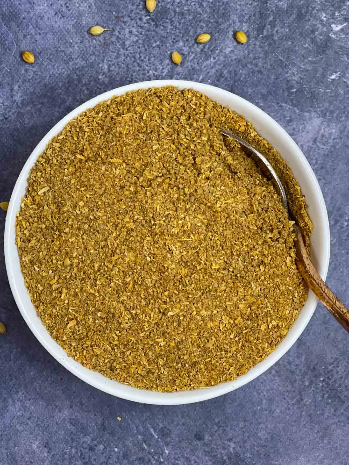 homemade coriander powder in a bowl with a spoon