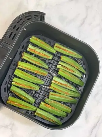 step to place the ladies finger in an air fryer basket