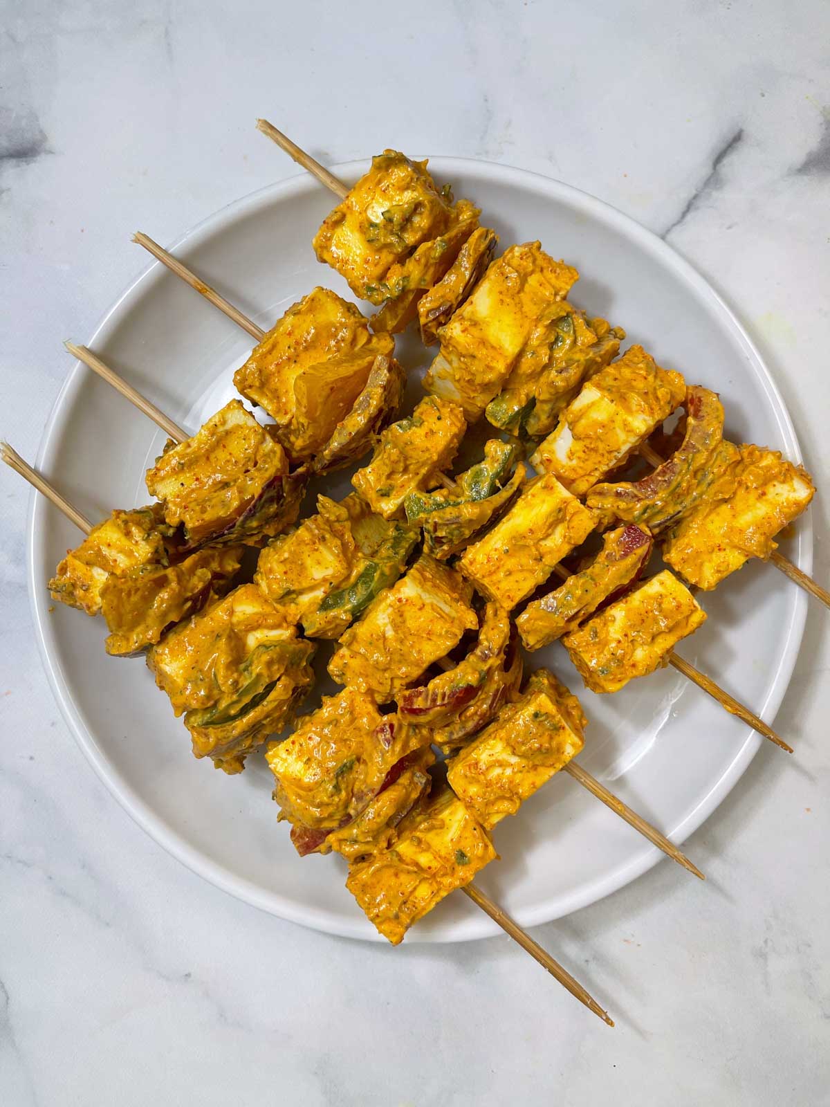 paneer tikka lined on a plate 