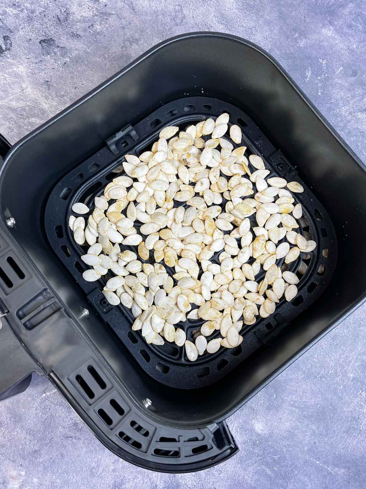 seasoned seeds on the air fryer basket