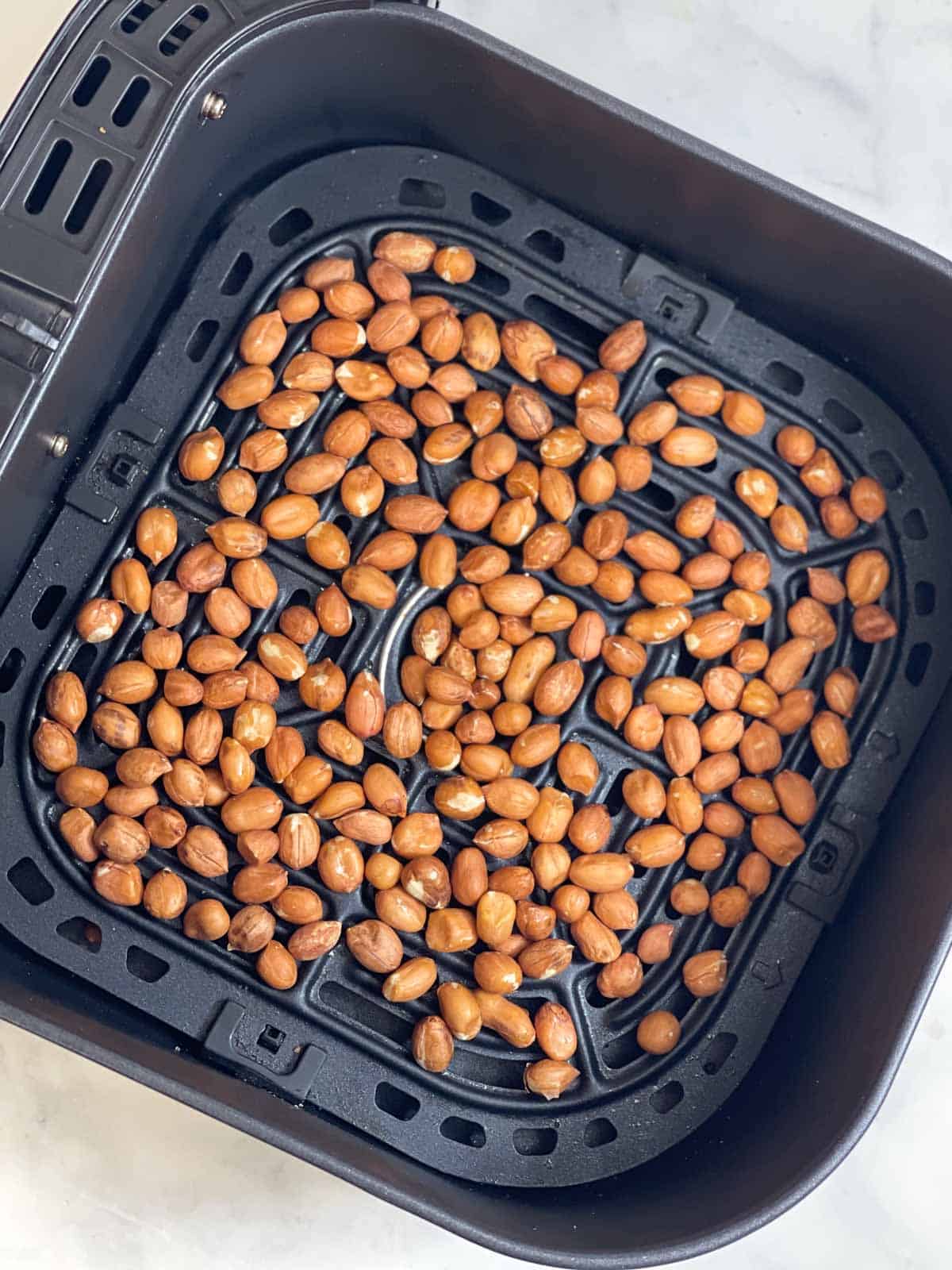 raw peanuts in the air fryer basket