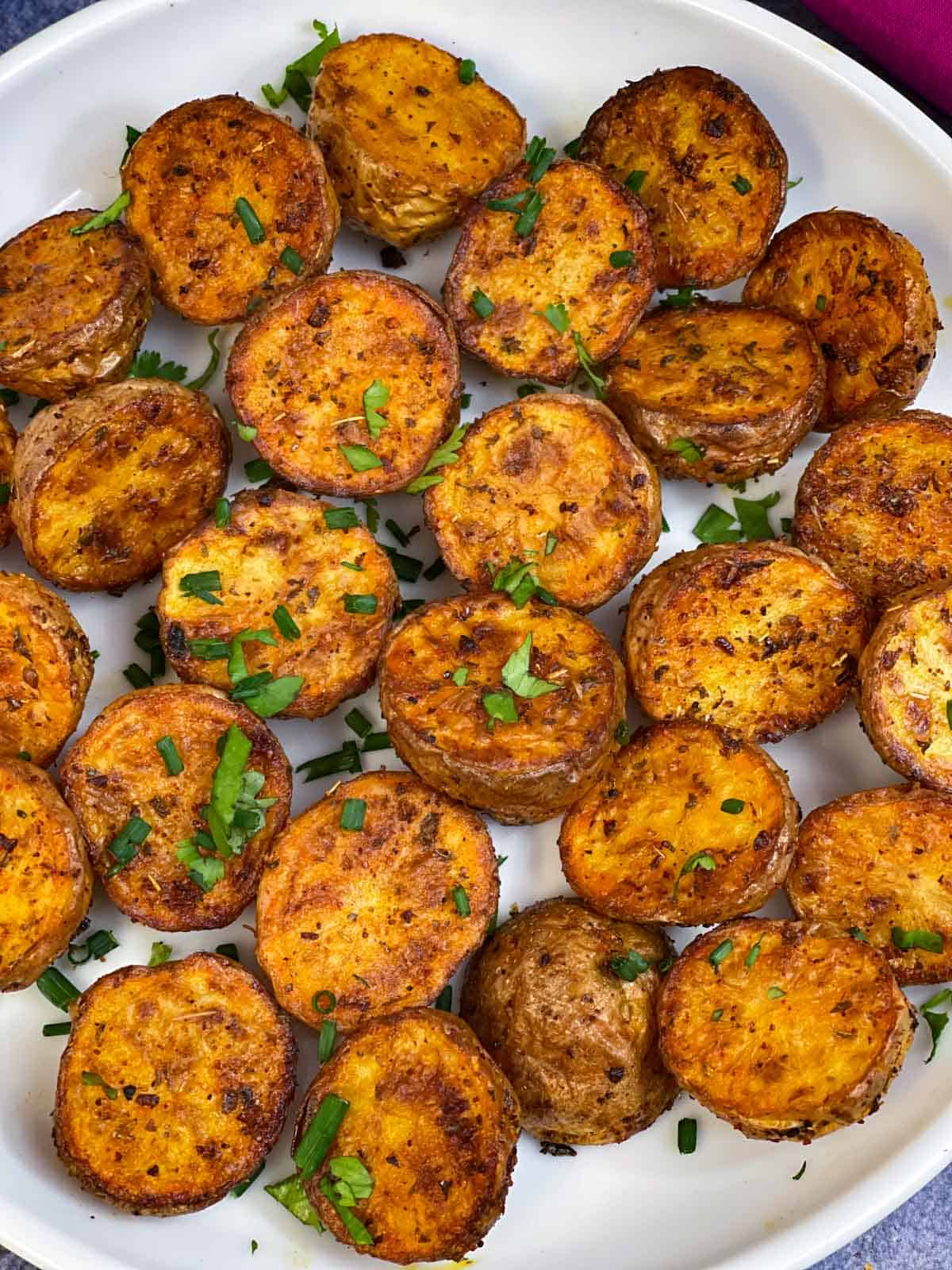 air fryer roasted bay potatoes serve don a plate garnished with parsley