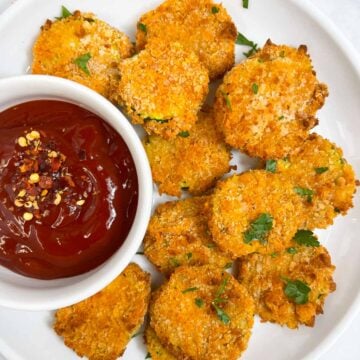 zucchini chips served on a plate with tomato ketchup