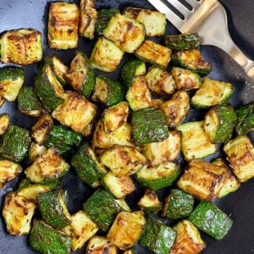 air fryer zucchini on a plate with a fork