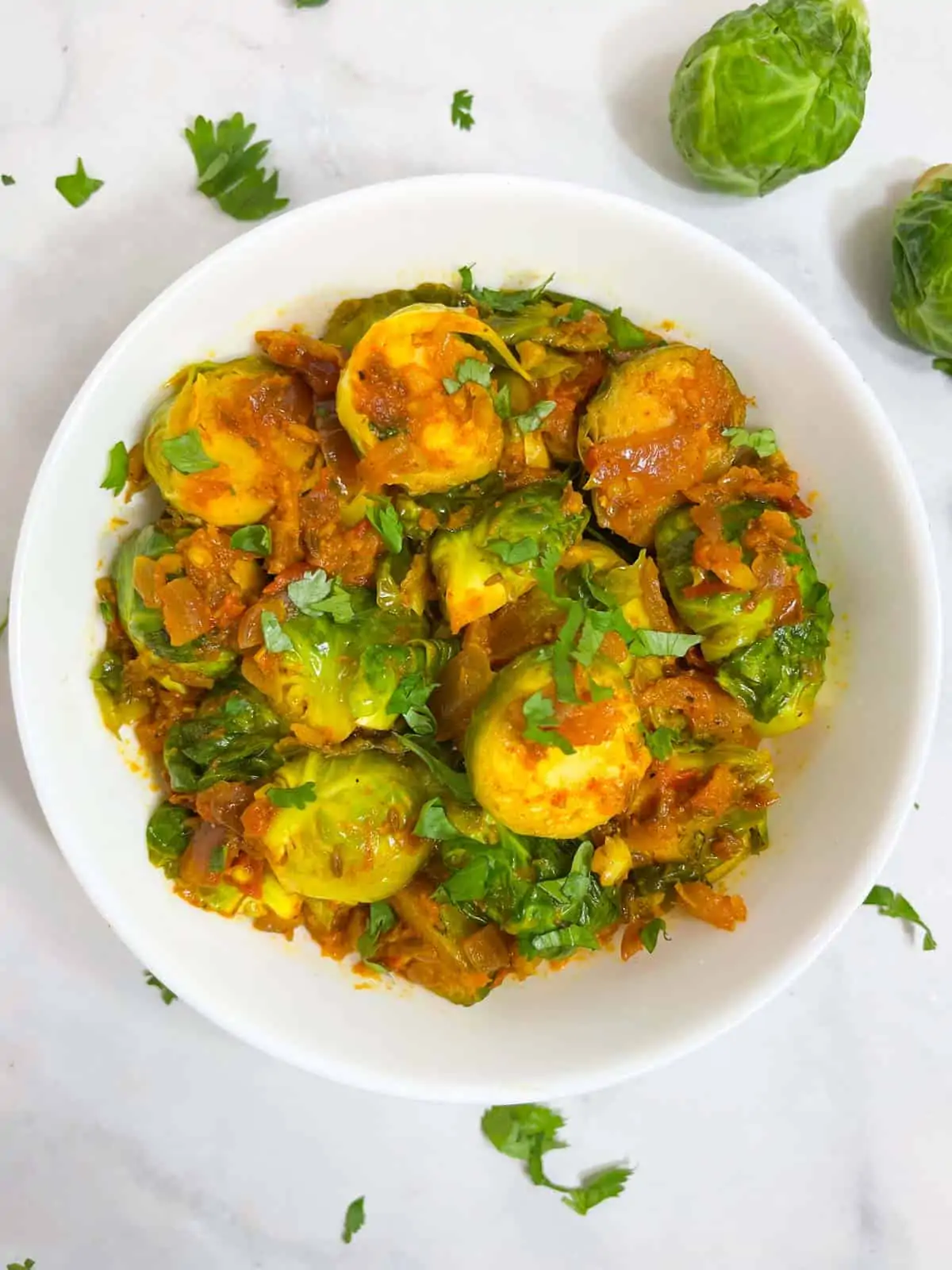 brussels sprouts sabzi in a bowl garnished with cilantro
