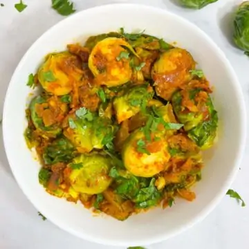 indian brussel sprouts curry served in a bowl garnished with coriander leaves