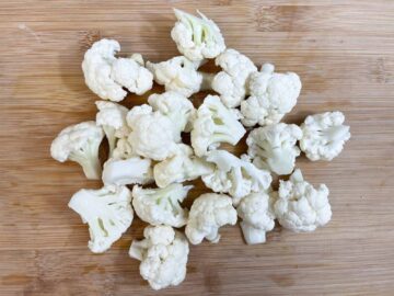 cauliflower florets on a chopping board