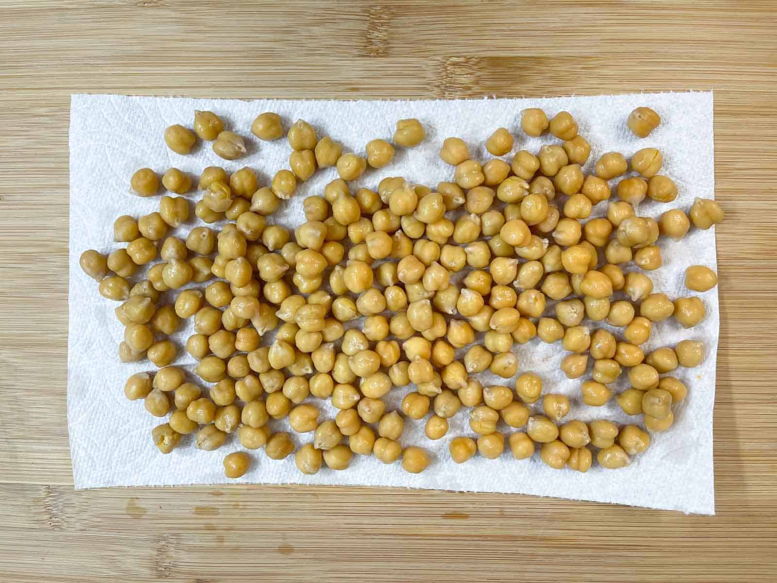 cooked chickpeas on a paper towel for drying