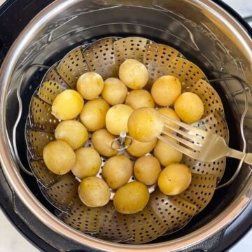 steamed baby potatoes in a steamer basket in instant pot