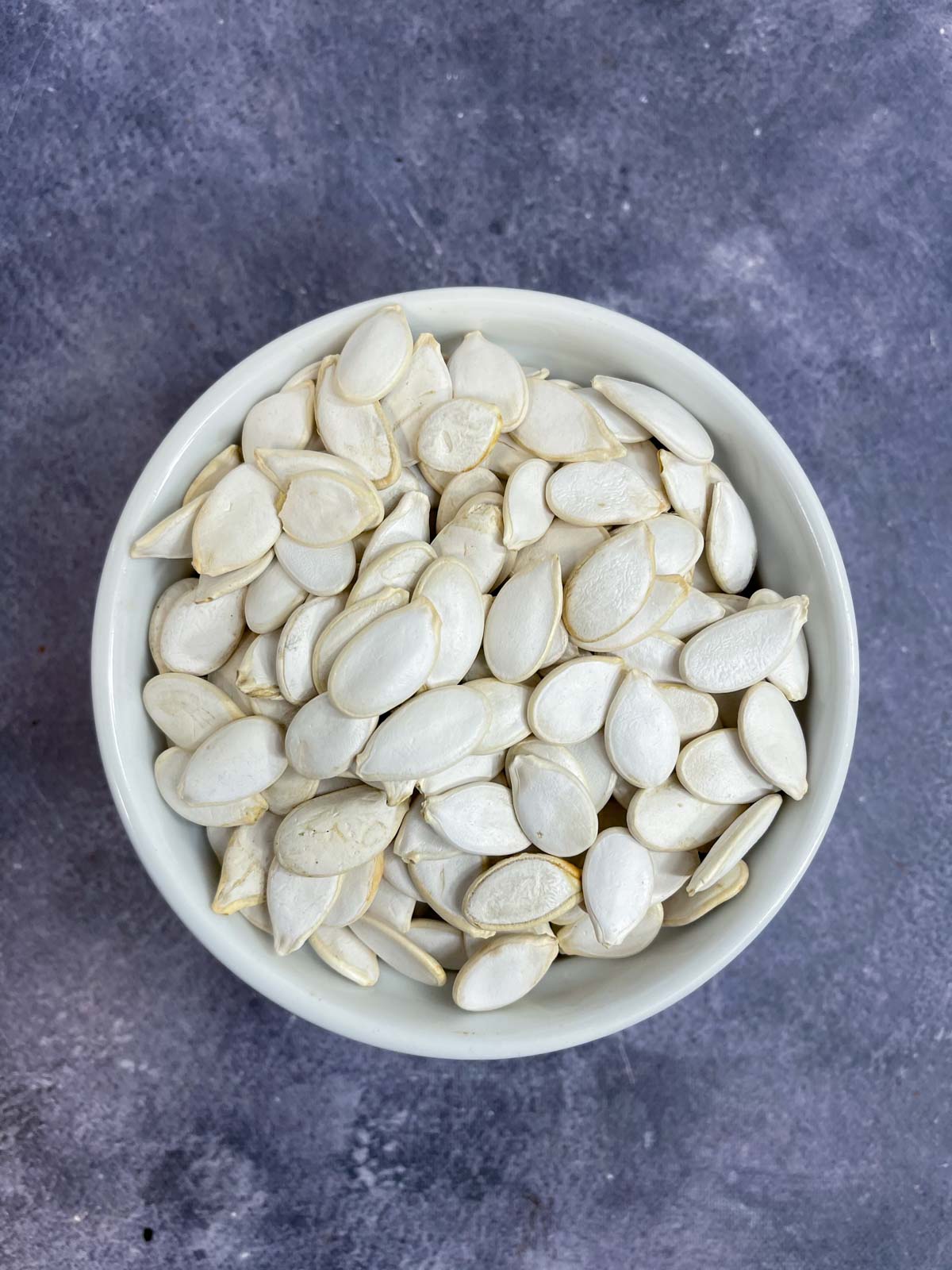 raw pumpkin seeds in a bowl