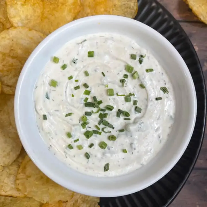 sour cream dip served in a bowl with chips