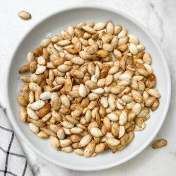 roasted pumpkin seeds served on a plate