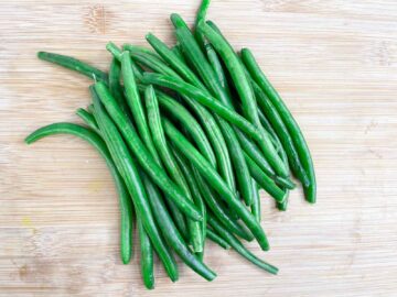 green beans on a wooden plate