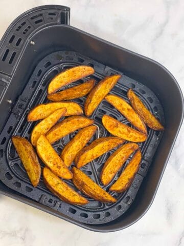 air fryer potato wedges in the basket