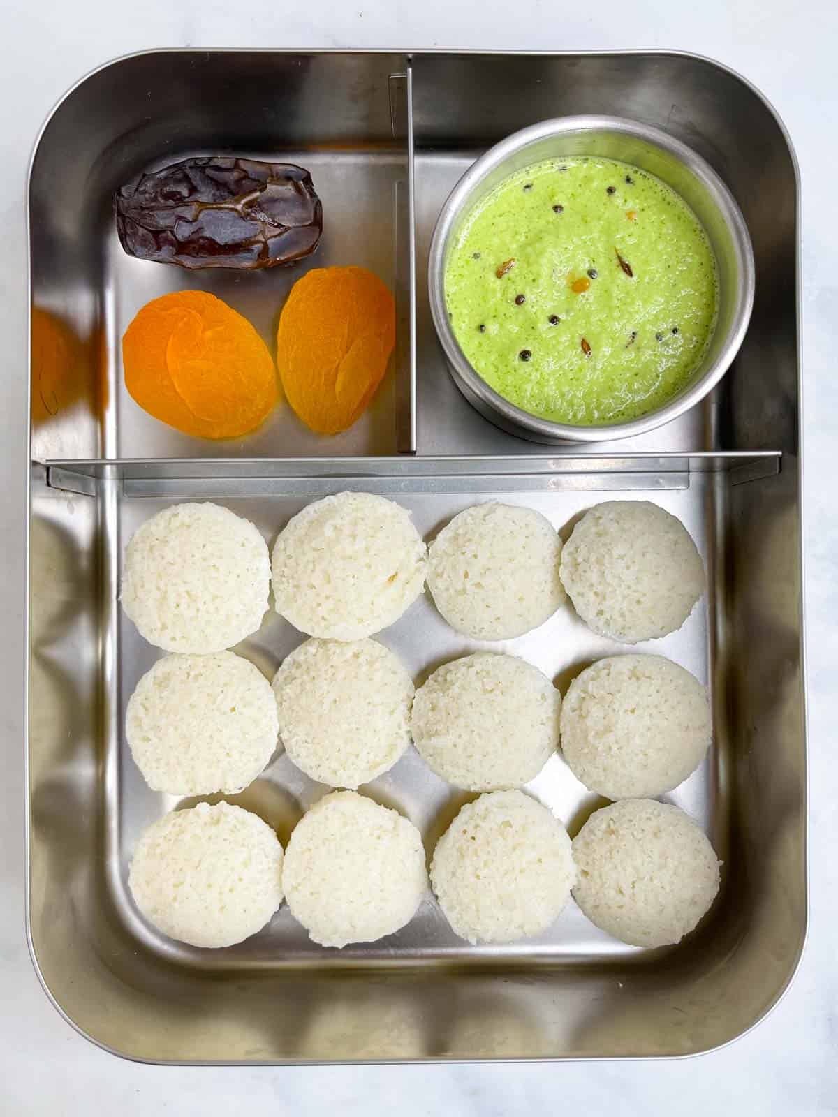 rava idli with chutney, dates and dried apricots in bento steel lunch box
