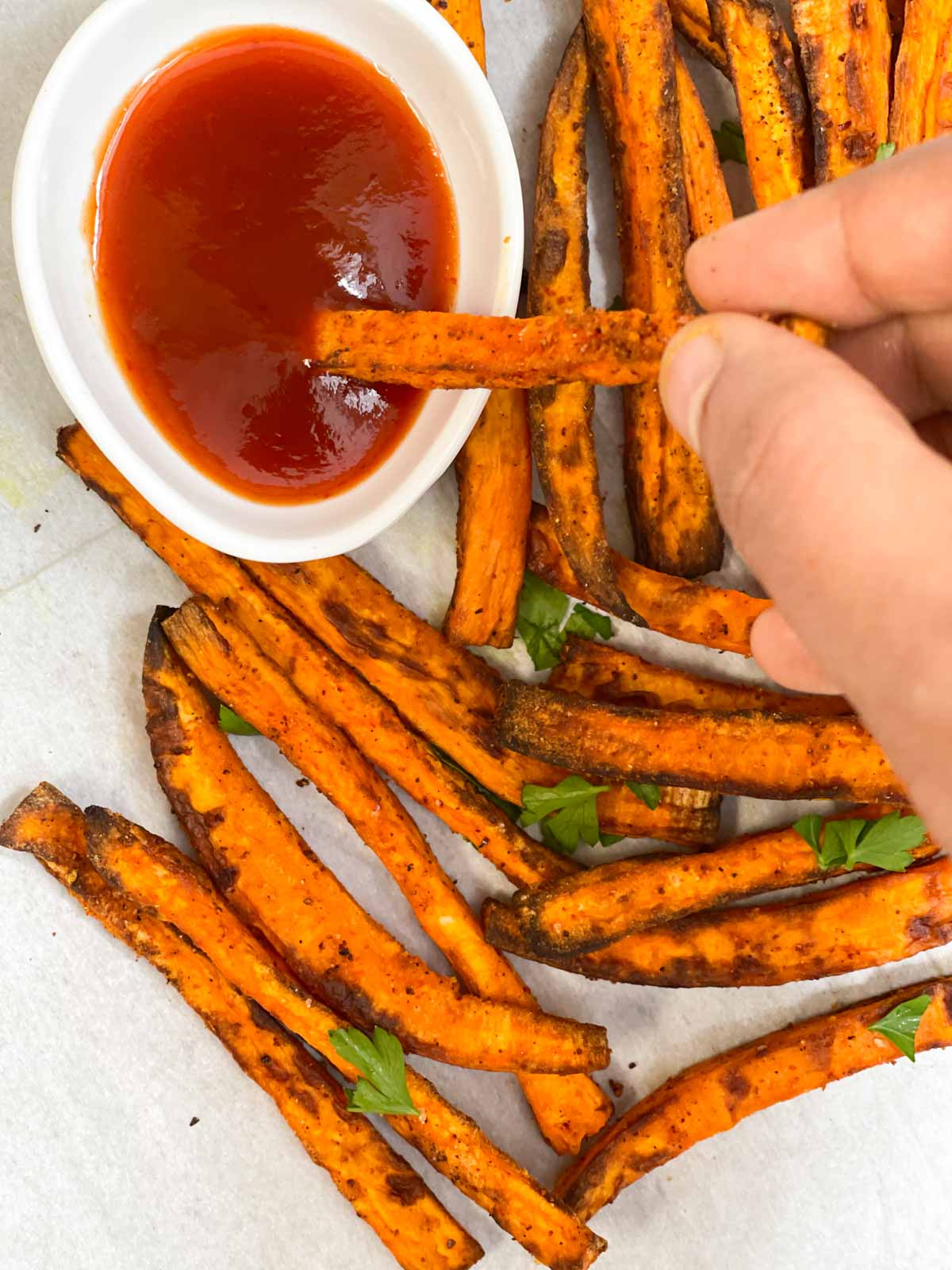 sweet potato fries dipped in ketchup